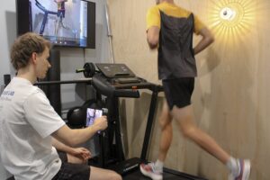 Kade recording a man's running gait for a running assessment